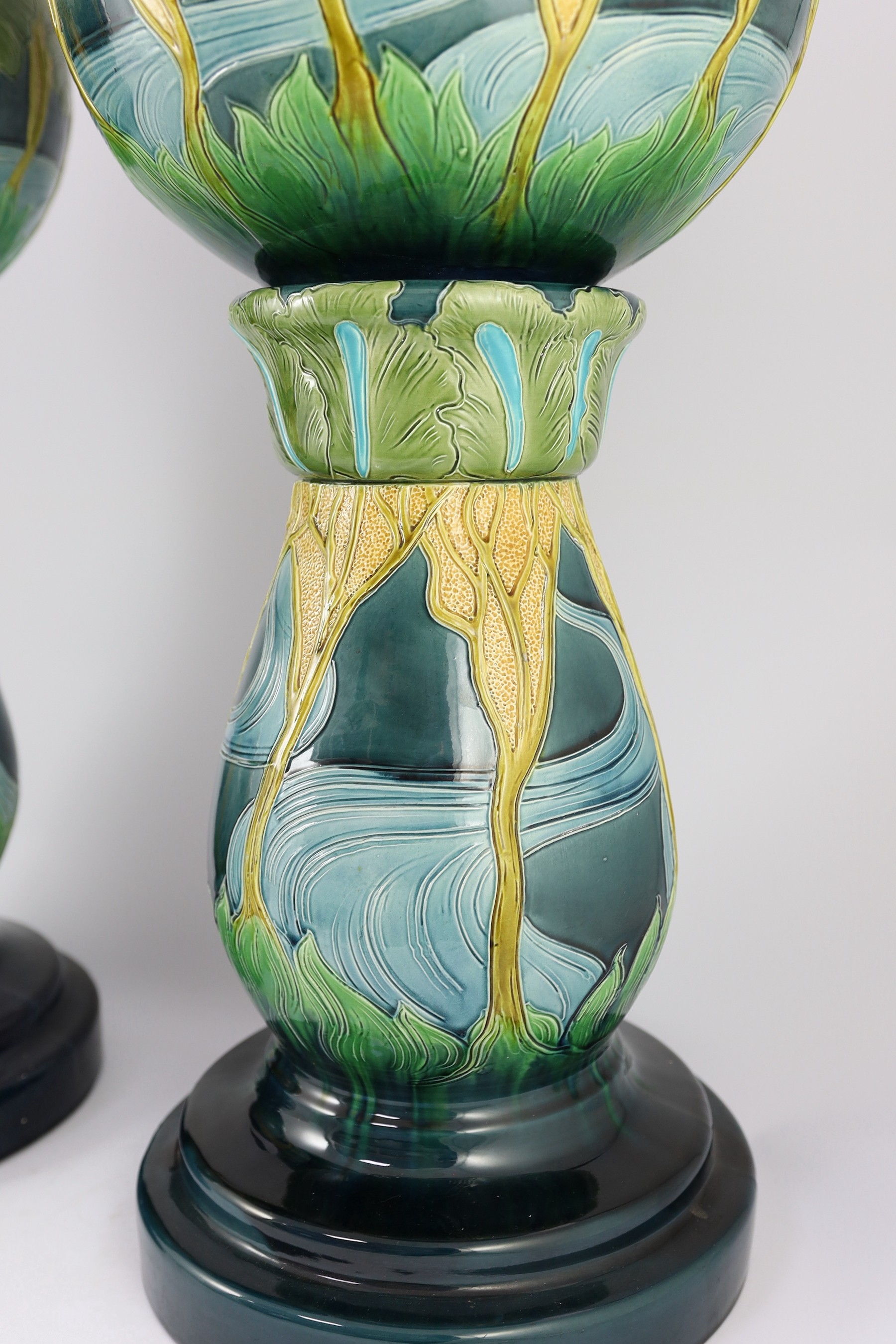 A pair of Burmantofts Art Nouveau faience jardinieres on matching pedestals, c.1900, total height 69cm, diameter 32cm, minor faults